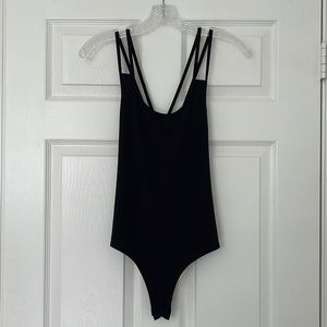 Black cross-cross back, spaghetti straps, thong bodysuit.